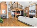 Open concept living area with hardwood floors and exposed brick at 3260 Curtis St, Denver, CO 80205