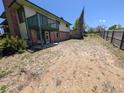 A wide view of the backyard showing a brick foundation, deck and fence at 327 S Pine St, Elizabeth, CO 80107