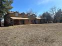 A large backyard behind a brown wood and brick two-story home at 5449 S Locust St, Greenwood Village, CO 80111