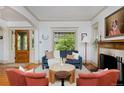 Cozy living room showcasing hardwood floors, a decorative leaded glass window, and a fireplace with ornate mantel at 747 N Downing St, Denver, CO 80218