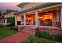 Inviting front porch with rocking chairs, brick flooring, and classic columns, perfect for relaxing outdoors at 747 N Downing St, Denver, CO 80218