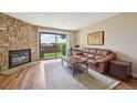 Bright living room featuring a stone fireplace and sliding doors to the outside at 7474 E Arkansas Ave # 13-02, Denver, CO 80231