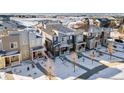 Aerial view of townhomes in a snow-covered community at 23527 E 5Th Pl, Aurora, CO 80018