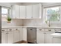 Bright, updated kitchen featuring sleek stainless steel appliances, white cabinetry, and modern fixtures at 4567 Grove St, Denver, CO 80211