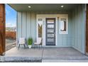 Inviting front porch with a modern front door and space for relaxing at 919 Russell St, Golden, CO 80401