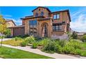 Beautiful home with stone accents, a tiled roof, manicured landscaping, and an inviting front entrance at 2256 S Isabell Ct, Lakewood, CO 80228