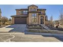 Beautiful two-story home showcasing a well-manicured lawn, stone accents, and a driveway at 2256 S Isabell Ct, Lakewood, CO 80228