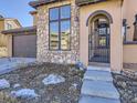 Close-up of the front door and façade showcasing a decorative stone wall and gated entrance at 2256 S Isabell Ct, Lakewood, CO 80228