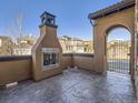 Outdoor living space with a cozy fireplace and decorative privacy screen at 2256 S Isabell Ct, Lakewood, CO 80228