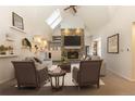 Bright living room featuring a stone fireplace, vaulted ceiling, skylight, and comfortable seating at 102 S High St, Breckenridge, CO 80424