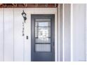 Close-up of a black door with a transom window, light fixture, and unit number at 1128 S Ventura Cir # B, Aurora, CO 80017