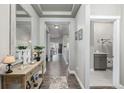 Inviting hallway featuring wood floors, stylish console table, and neutral paint at 11884 Barrentine Loop, Parker, CO 80138