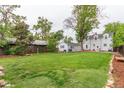 Expansive backyard with lush green grass and mature trees, perfect for outdoor activities and relaxation at 134 S 5Th Ave, Brighton, CO 80601