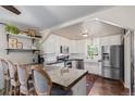 Bright kitchen featuring white cabinetry, stainless steel appliances, and a counter with barstool seating at 134 S 5Th Ave, Brighton, CO 80601