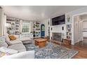 Cozy living room with built-in bookshelves, fireplace, and a comfortable sectional sofa at 134 S 5Th Ave, Brighton, CO 80601