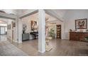 Bright, open-concept living room featuring hardwood floors, neutral paint, and a cat tree at 22778 E Alamo Ln, Aurora, CO 80015