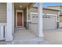 Inviting front porch with elegant columns and a well-maintained two-car garage at 10555 Boston St, Commerce City, CO 80640