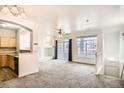 Bright living room with fireplace, large windows, and sliding glass door to balcony at 12711 Colorado Blvd # 607F, Thornton, CO 80241