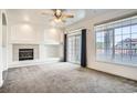 Living room features a fireplace, large windows, balcony access, and lots of light at 12711 Colorado Blvd # 607F, Thornton, CO 80241