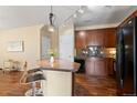 Cozy kitchen featuring dark cabinets, tile countertops and bar stool seating at 2662 S Cathay Way # 112, Aurora, CO 80013