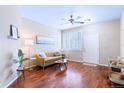 Inviting living room with hardwood flooring, a ceiling fan, and plantation shutters at 2662 S Cathay Way # 112, Aurora, CO 80013