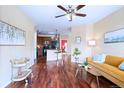 Open-concept living space with hardwood floors, a kitchen view, and comfortable seating at 2662 S Cathay Way # 112, Aurora, CO 80013