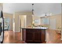 Open concept living area with hardwood floors, an island and neutral paint at 2662 S Cathay Way # 112, Aurora, CO 80013
