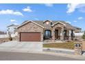 Beautiful home featuring a stone archway entry, stone accents and a large driveway at 156 Chapel Hill Cir, Brighton, CO 80601