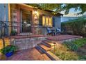 Inviting front porch with seating, beautiful landscaping, and brick accents at 1250 S Josephine St, Denver, CO 80210