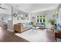 Bright living room featuring hardwood floors, large windows, and stylish decor at 1250 S Josephine St, Denver, CO 80210