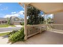 Relaxing covered porch overlooking a quiet street and a well-maintained neighborhood at 14139 W Warren Dr, Lakewood, CO 80228