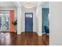 Inviting entryway with hardwood floors, a navy blue door, and a stylish light fixture at 1131 S York St, Denver, CO 80210