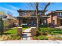 Charming brick two-story home with a landscaped front yard, walkway, and inviting entrance with front porch at 1131 S York St, Denver, CO 80210