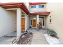 Front entry of the home with double doors and landscaping at 990 S Locust St # D, Denver, CO 80224