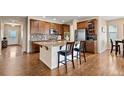 Modern kitchen featuring granite countertops, a kitchen island, and stainless steel appliances at 9382 Pike Way, Arvada, CO 80007