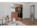 View of the open-concept living area flowing seamlessly into an updated kitchen at 1695 S Beach Ct, Denver, CO 80219