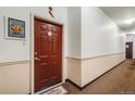 The condo entryway showcases a front door and a neutral hallway at 15700 E Jamison Dr # 6-101, Englewood, CO 80112