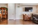 A cozy living room features hardwood floors, neutral walls and a tv at 15700 E Jamison Dr # 6-101, Englewood, CO 80112
