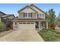 Charming two-story house with a two car garage, well-kept lawn and landscaping plus covered porch with rocking chairs at 2115 Coach House Loop, Castle Rock, CO 80109