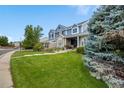 Stunning two-story blue home with mature landscaping and inviting front porch at 1496 Meyerwood Cir, Highlands Ranch, CO 80129