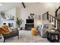 Comfortable living room featuring a cozy fireplace, modern decor, and an adjacent staircase at 6948 Buckskin Dr, Littleton, CO 80125