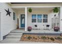 Inviting front porch with rocking chairs, decorative plants, and a welcoming entrance with curb appeal at 4422 Mt Shavano St, Brighton, CO 80601