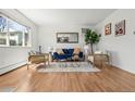 Inviting living room with hardwood floors, comfortable seating, and a large window at 7309 W Hampden Ave # 601, Lakewood, CO 80227