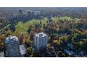 Aerial view of a residential neighborhood with lush green trees, buildings, and a large park nearby at 1200 N Humboldt St # 1003, Denver, CO 80218