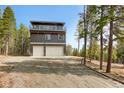 Two-story exterior featuring a garage with a second story balcony at 586 Alpine Way, Idaho Springs, CO 80452