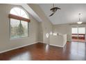 Bright living room with wood floors and large window with view of the trees outside at 18206 E Tanforan Pl, Aurora, CO 80015