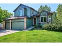 Charming two-story home with a three-car garage and mature landscaping at 5651 S Himalaya Way, Centennial, CO 80015