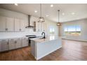 Modern kitchen featuring island, stainless steel appliances, and white cabinets at 14408 Hop Clover Trl, Parker, CO 80134