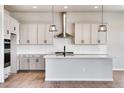 Spacious kitchen with white cabinets, quartz countertops, and island at 14408 Hop Clover Trl, Parker, CO 80134