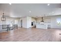 Open concept living area with hardwood floors and modern fireplace at 14408 Hop Clover Trl, Parker, CO 80134